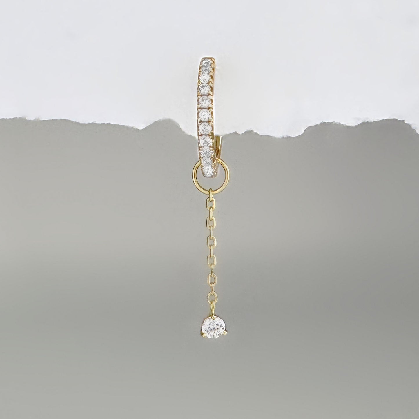 Gold & gemstone chain earring charm on a diamond huggie hoop earring