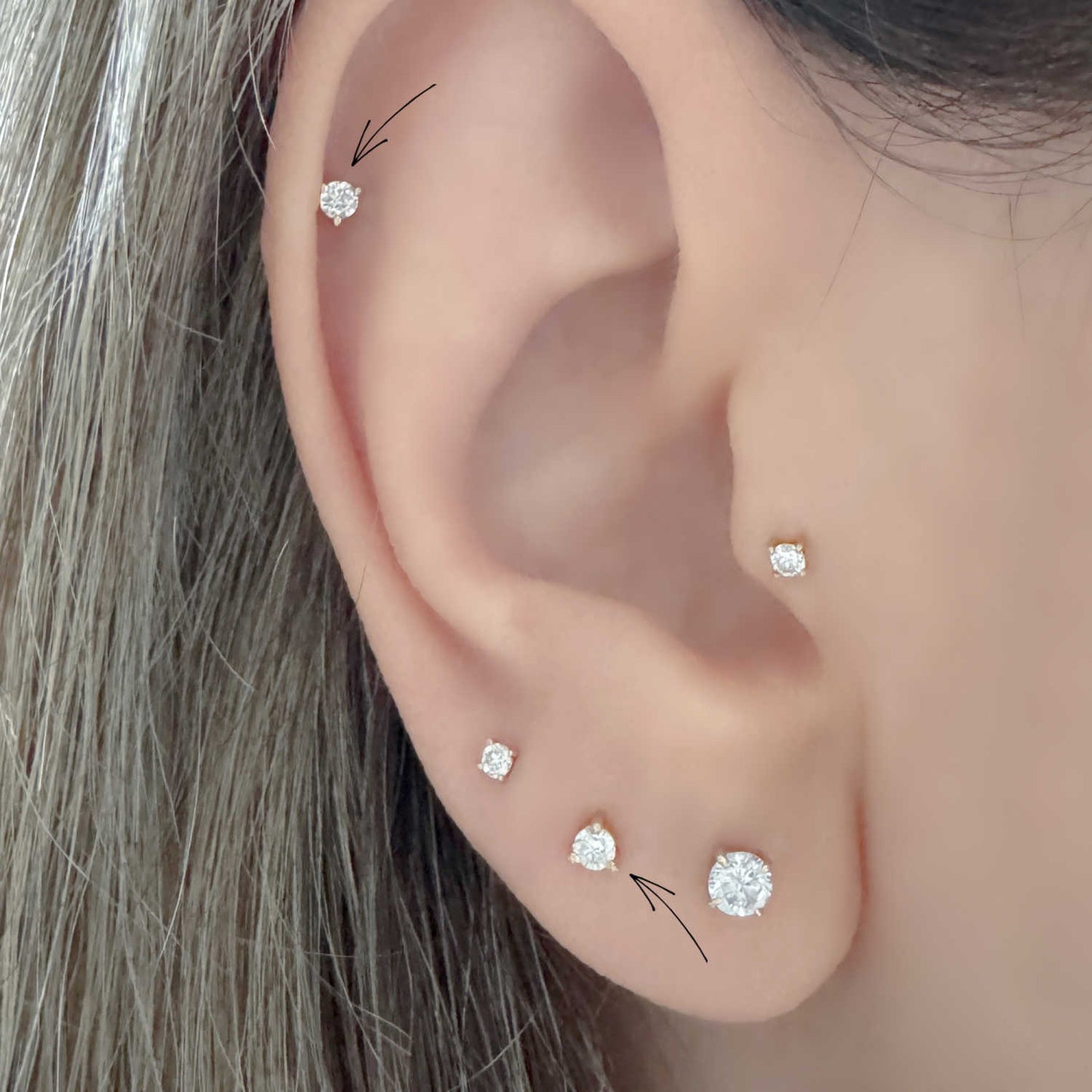 Woman Wearing Lab Grown Diamond Stud Earrings in Helix, Tragus & Lobe | 14k Gold Flat Back Cartilage Piercing Studs from Two of Most