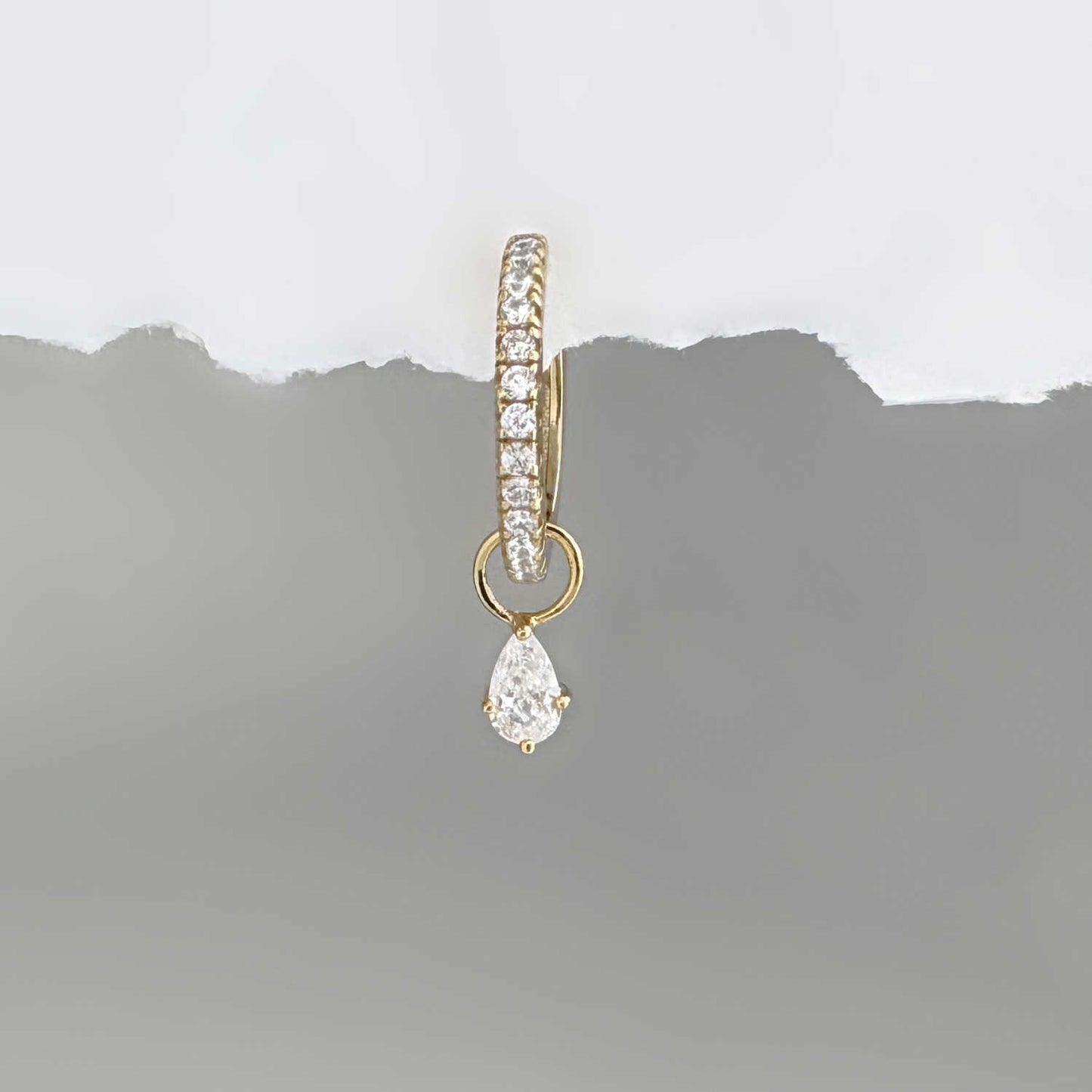 Gold hoop earring with a pear teardrop-shaped cubic zirconia diamond earring charm