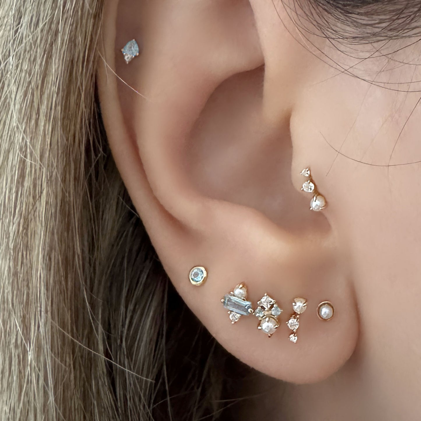 Woman Wearing Pearl Stud Earrings in Cartilage Piercings, 14k Gold Flat Back Piercing Jewelry from Two of Most