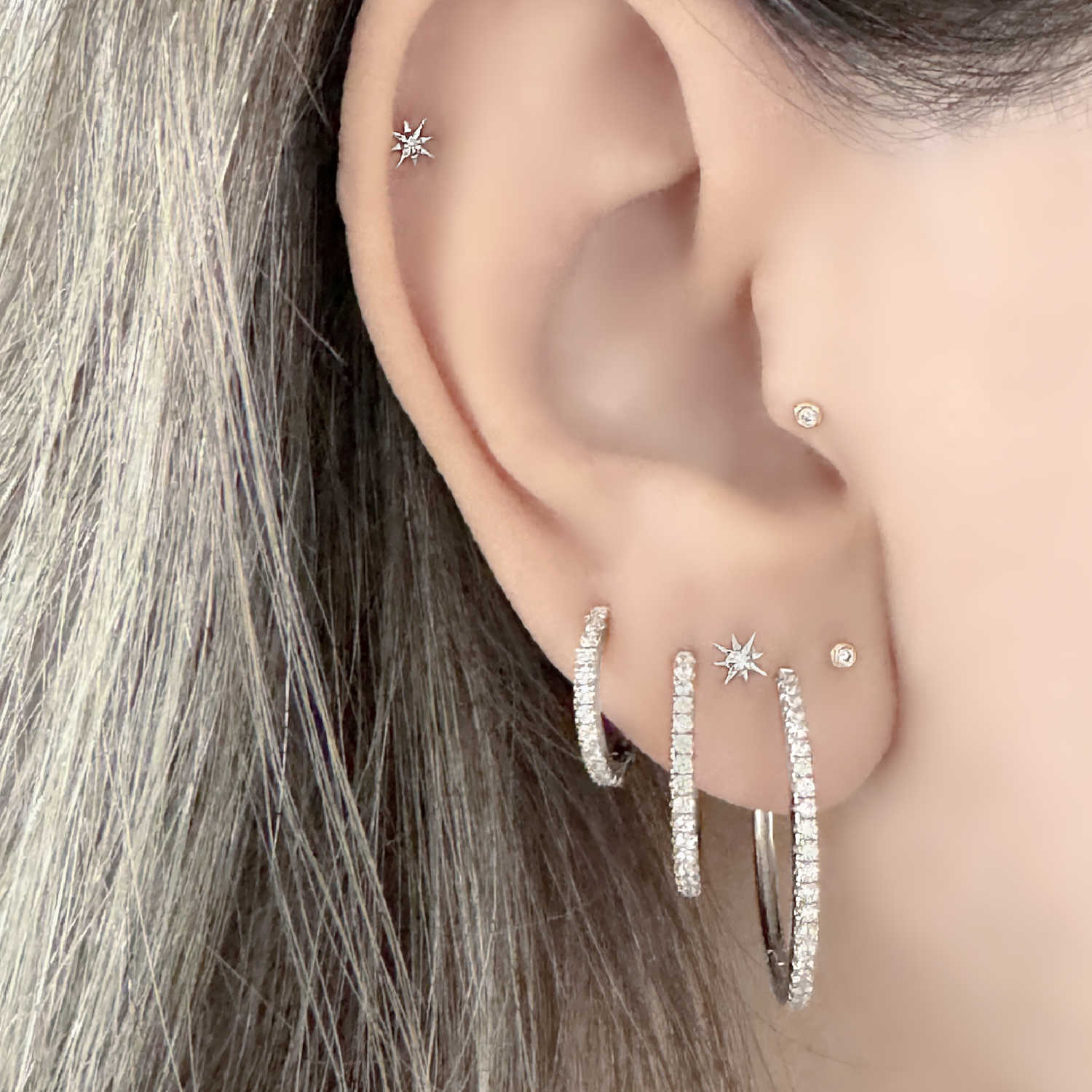 Graduated Gemstone Hoops and White Gold Cartilage Earrings on Woman, Piercing Jewelry for Helix, Tragus, Conch & Lobe from Two of Most