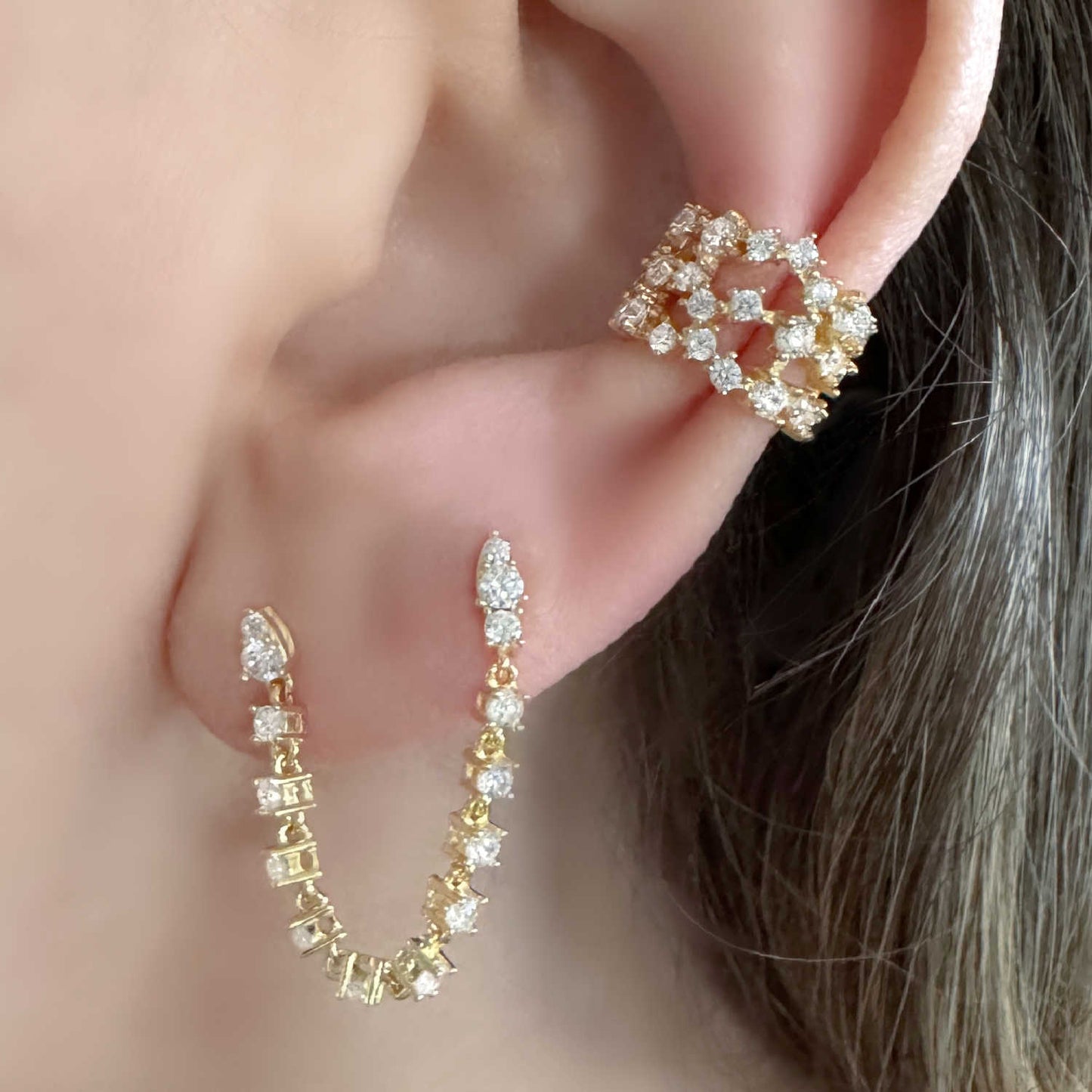 Woman Wearing Wide Gold and Gemstone Ear Cuff and Tennis Double Piercing Earring