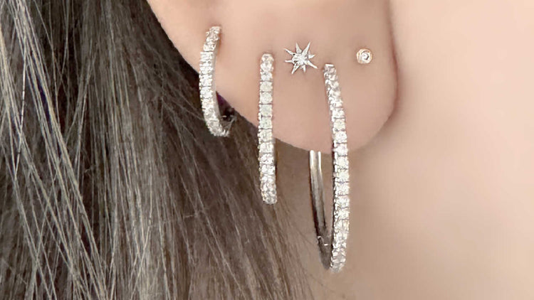 Woman wearing set of 3 graduated diamond hoop earrings