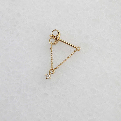 Side view of a delicate 14k gold front back chain earring with a floating diamond charm