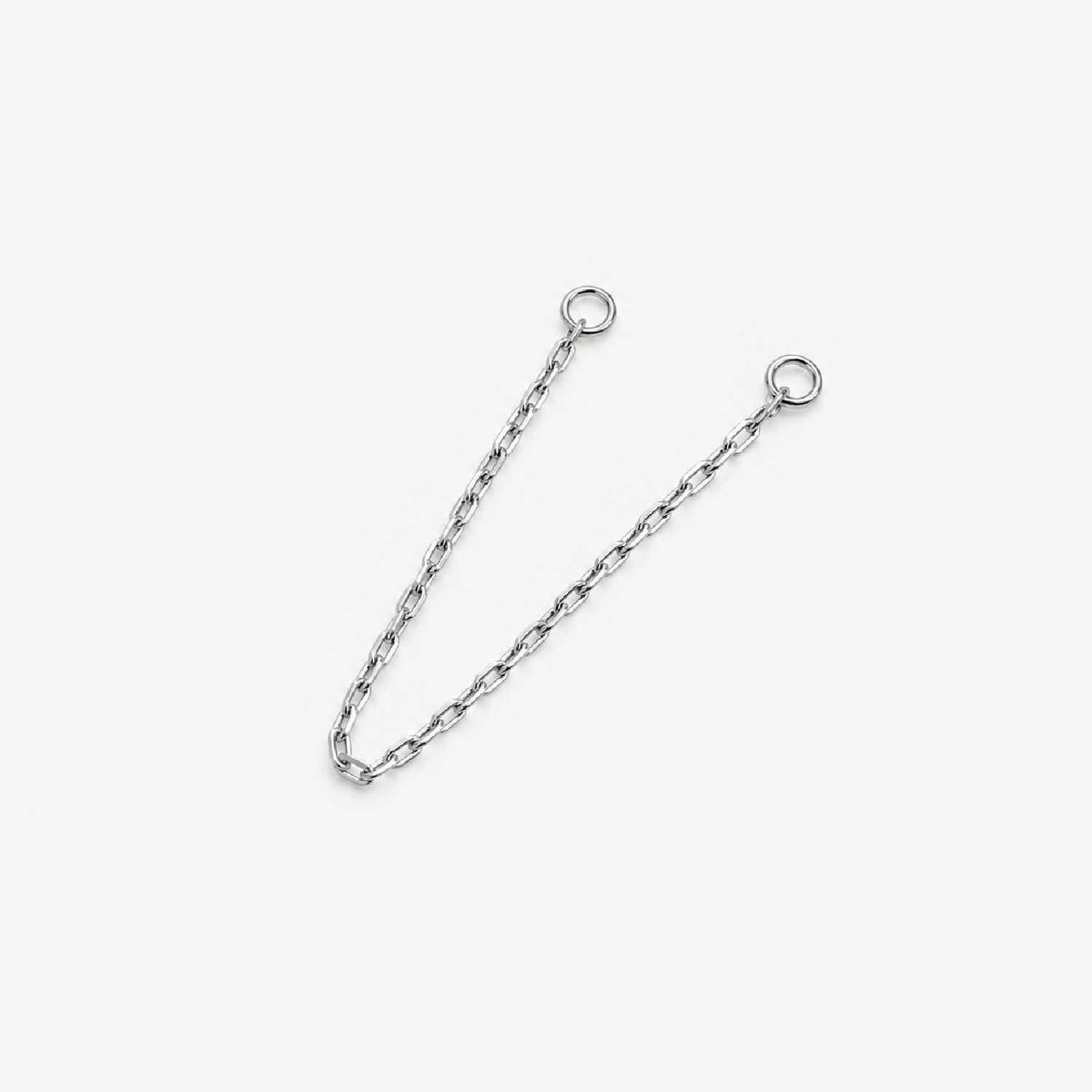 A 14k white gold cable chain double piercing earring charm with two circular jump ring ends, photographed on a plain light background.