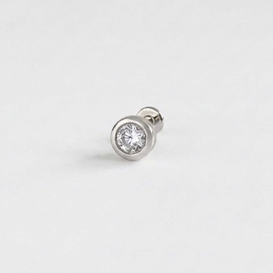 A single 14k solid white gold stud flat back earring with a bezel-set diamond gemstone, shown on a clean, light gray background.