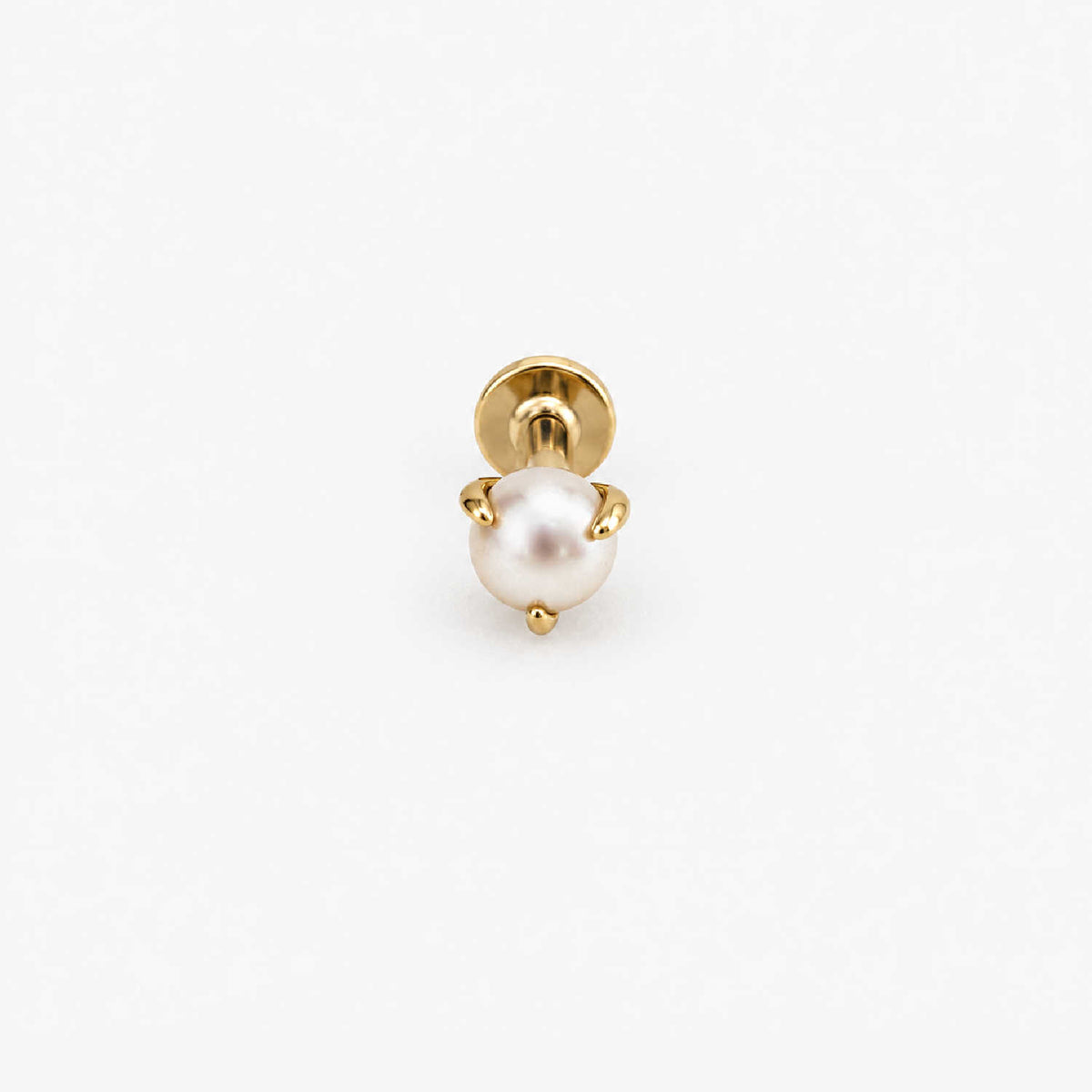 A single 14k gold flat back stud earring featuring a round, lustrous white pearl held in a prong setting, shown against a plain white background.
