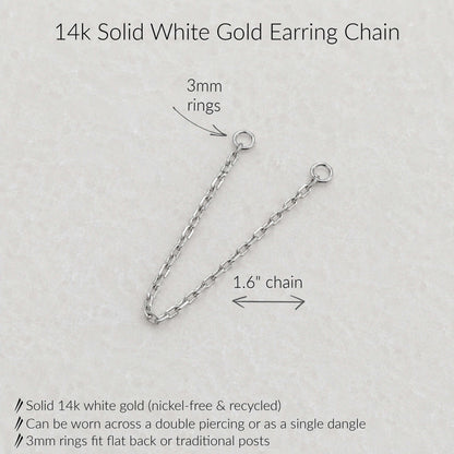 A 14k solid white gold earring chain shown on a light textured background with measurement annotations indicating 3mm rings and a 1.6-inch chain length, plus product feature text.