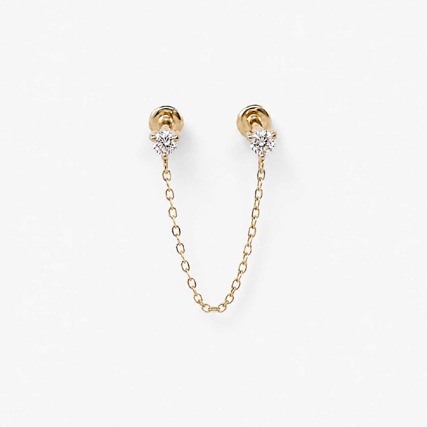 A pair of 14k gold flat back earrings with a short chain connecting the diamond studs