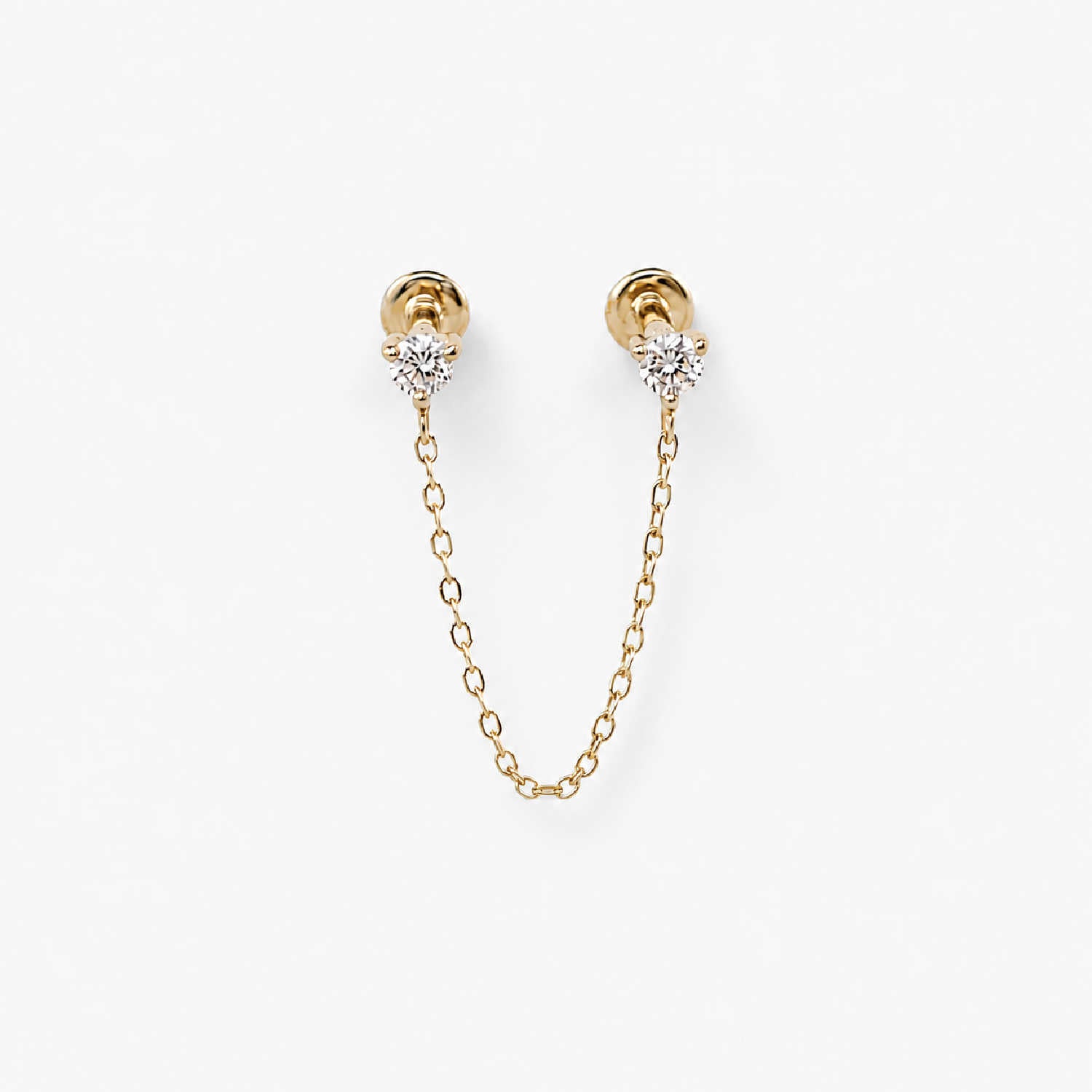A pair of 14k gold flat back earrings with a short chain connecting the diamond studs