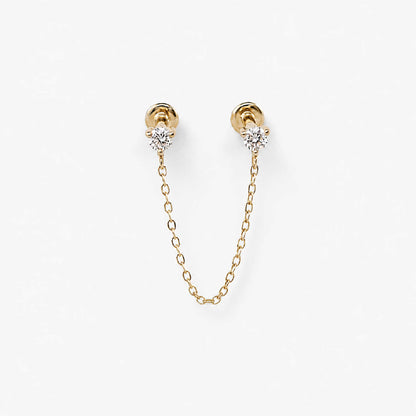 A pair of 14k gold flat back earrings with a short chain connecting the diamond studs
