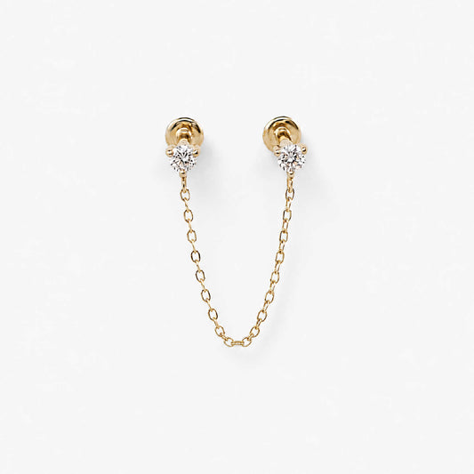 A pair of 14k gold flat back earrings with a short chain connecting the diamond studs