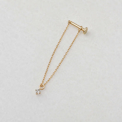 Side view of a long delicate 14k gold flat back chain earring with a floating diamond charm