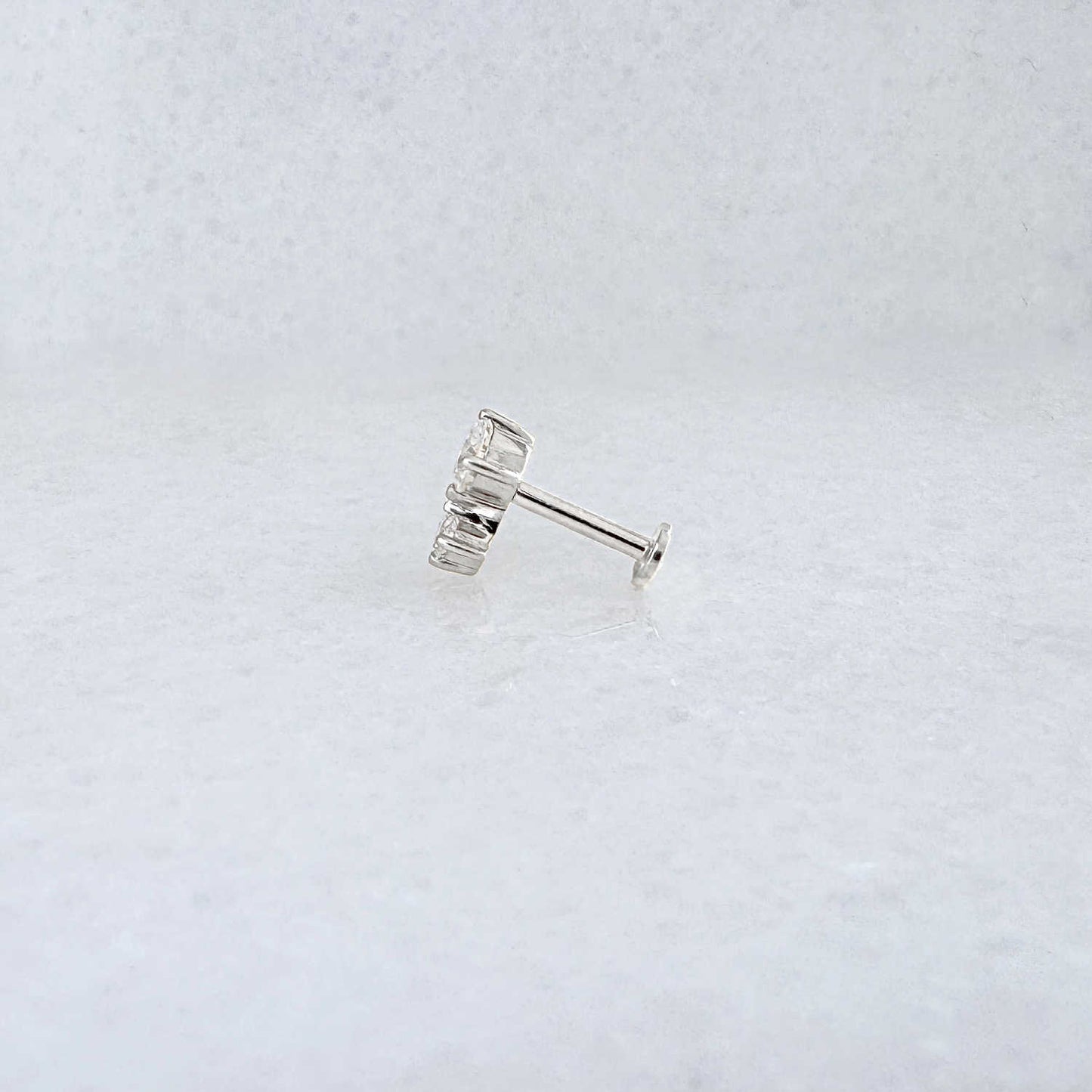 Side view of a solid 14k gold flat back stud earring with 1/2 Carat of diamonds 