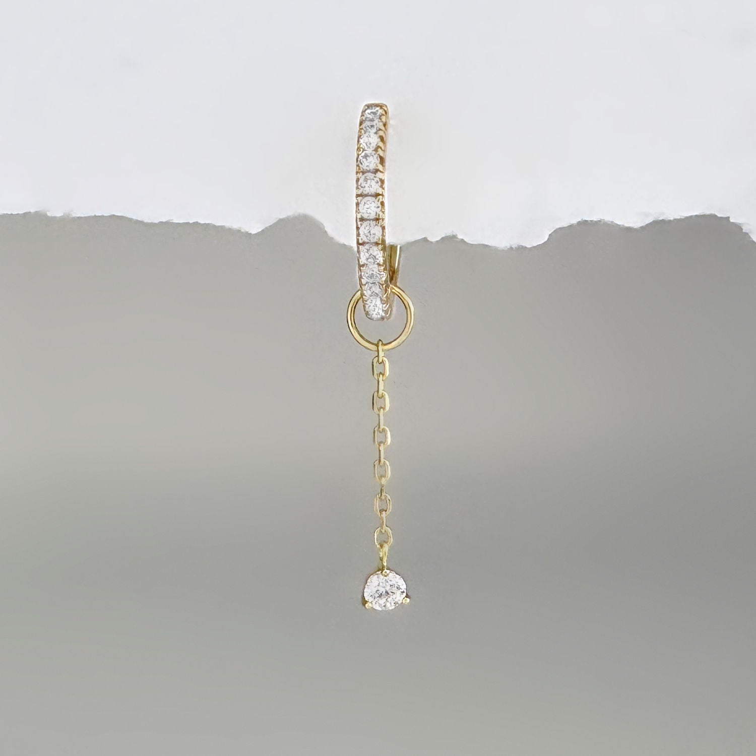 Gold & gemstone chain earring charm on a diamond huggie hoop earring