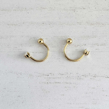 Pair of gold front to back hoop earrings, side view