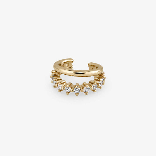 A gold ear cuff earring adorned with a row of small clear cubic zirconia stones, shown on a light gray background.