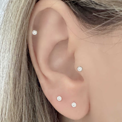 Woman Wearing Lab Grown Diamond and White Gold Earrings in Helix, Tragus and Lobe Piercings
