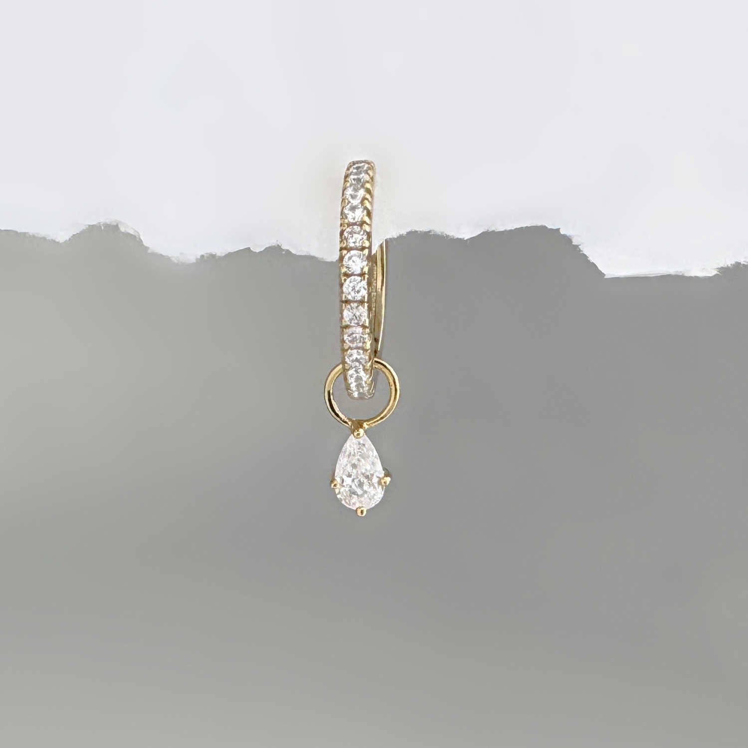 Gold hoop earring with a pear teardrop-shaped cubic zirconia diamond earring charm