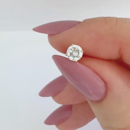 Video of a 1/3 carat diamond stud earring in 14k yellow gold, showing the stud from all angles and operation of flat screw back labret post