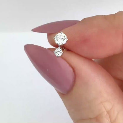 Video of a 1/2 carat two-stone diamond stud earring in 14k white gold, showing the stud from all angles and operation of flat screw back labret post