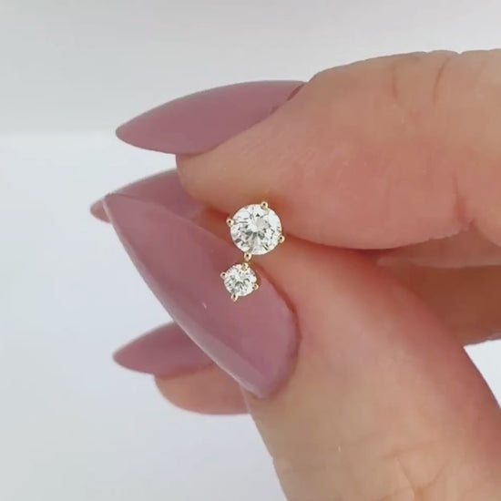 Video of a 1/2 carat two-stone diamond stud earring in 14k yellow gold, showing the stud from all angles and operation of flat screw back labret post