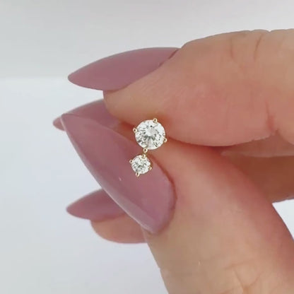 Video of a 1/2 carat two-stone diamond stud earring in 14k yellow gold, showing the stud from all angles and operation of flat screw back labret post