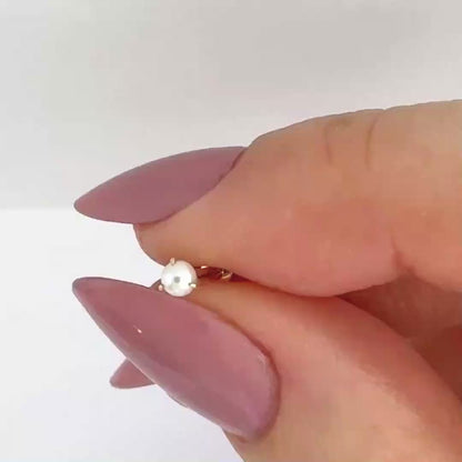 Video of a 14k gold & white pearl earring showing the stud from all angles and operation of flat screw back labret post