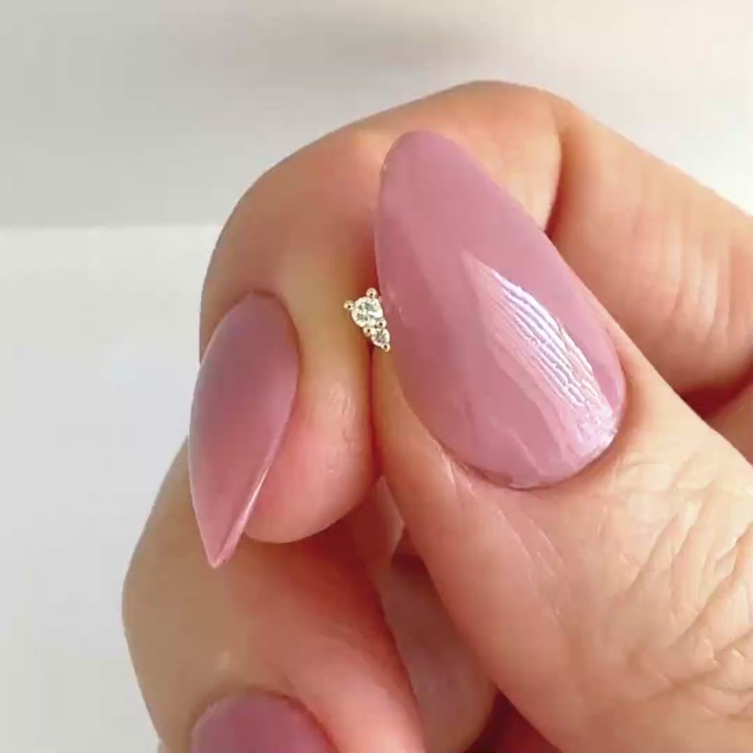 Video of a small two-stone diamond stud earring in 14k yellow gold, showing the stud from all angles and operation of flat screw back labret post