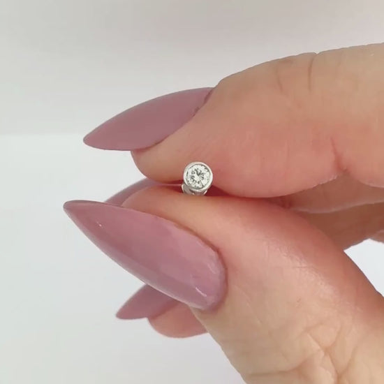Video of a 14k white gold & diamond earring showing the stud from all angles and operation of flat screw back labret post