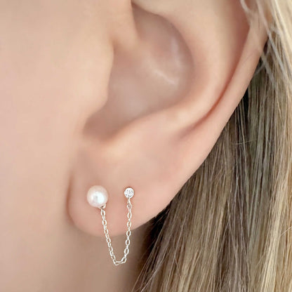 Woman wearing sterling silver double piercing earring with pearl stud