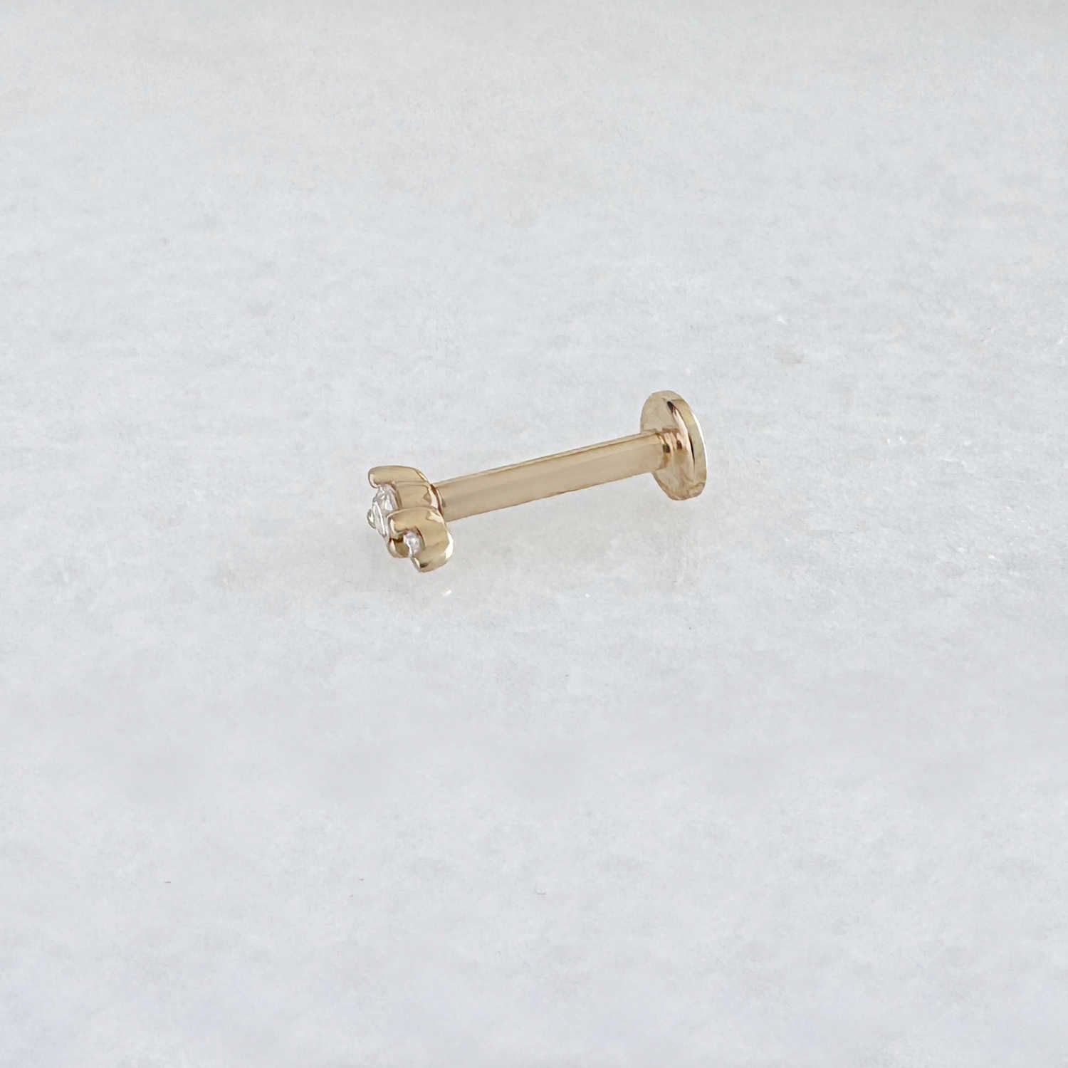 Side view of a solid 14k gold flat back stud earring with two diamonds. Tiny Diamond Cartilage Piercing Jewelry for Helix, Tragus, Conch or Lobe