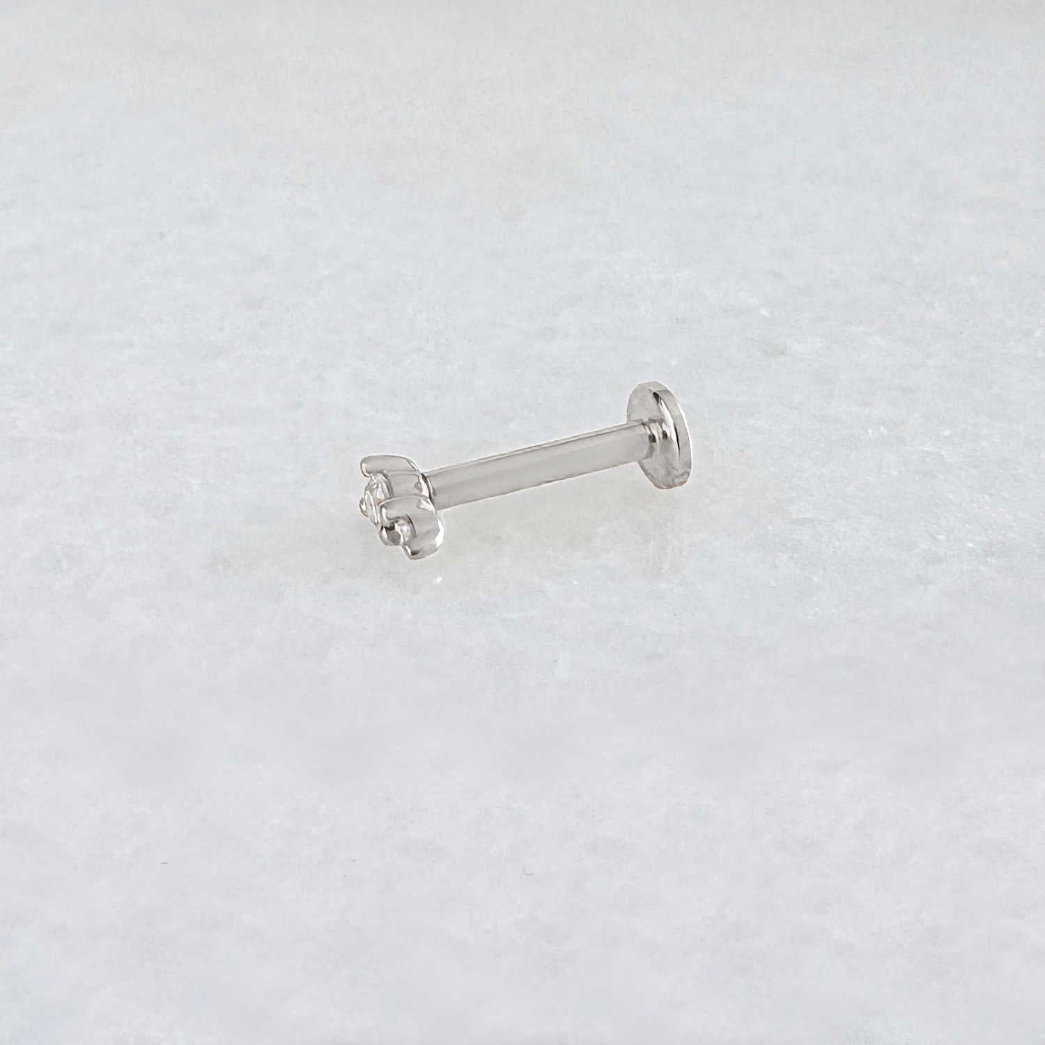 Side view of a solid 14k white gold flat back stud earring with two diamonds. Tiny Diamond Cartilage Piercing Jewelry for Helix, Tragus, Conch or Lobe