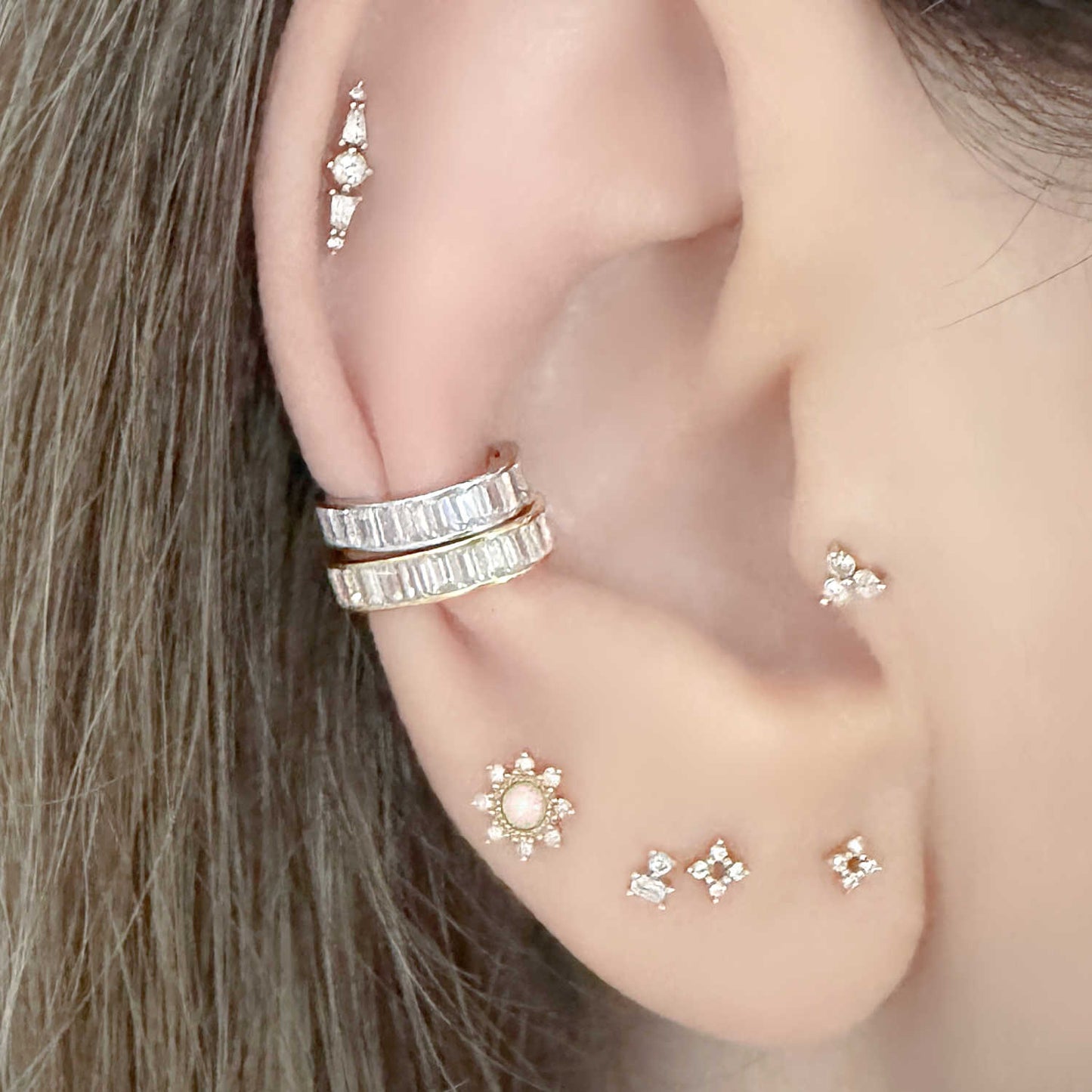 Woman Wearing Yellow and White Gold Baguette Ear Cuff Earrings